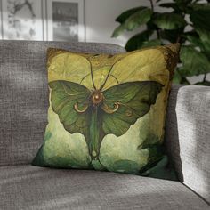 a green butterfly pillow sitting on top of a couch