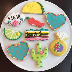 a white plate topped with lots of decorated cookies