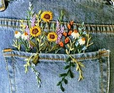 a pair of jeans with flowers in the back pocket