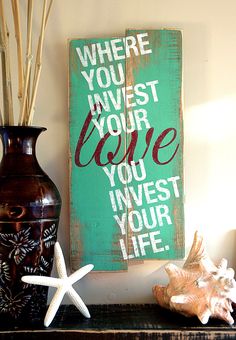 there is a sign that says where you invest your love, you invest your life