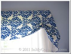 a blue and white window valance with an ornate design