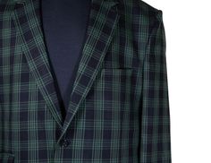 This Chiragh Apparel blazer is an elegant upgrade on dapper tailoring and features rich shades in a sumptuous fabric for elegant opulence. Fashioned from premium quality wool, this plaid check blazer features full lining in Japanese silk, a notch lapel, two-button closure and single-vented back. A left chest pocket and three flap pockets appoint the front while the inside has two (2) pockets on the left and one (1) pocket on the right. A flash of contrast piping is added to the jacket lining ins Elegant Fitted Green Blazer, Elegant Green Sport Coat For Business Casual, Elegant Green Fitted Outerwear, Elegant Fitted Green Outerwear, Elegant Green Blazer With Lapel Collar, Designer Fitted Sport Coat For Semi-formal Occasions, Elegant Tailored Green Sport Coat, Fitted Designer Sport Coat For Formal Occasions, Elegant Green Semi-formal Blazer