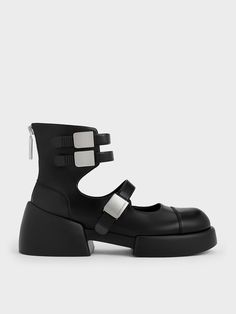 Our new seasonal take on classic ankle boots is both cool and modern. These shoes feature chunky soles that create a striking silhouette, paired with edgy buckled straps. The high-top design adds an extra chic element, making them stand out despite their simple black finish. They also include zippers at the back for easy wear, allowing you to slip in and out effortlessly, ensuring you look stylish even on the busiest days. Modern Chunky Platform Boots, Ankle-high Platform Boots With Buckle Punk Style, Ankle-high Platform Boots With Buckle Closure Punk Style, Modern Platform Ankle Moto Boots, Edgy Ankle Platform Boots With Buckle, Edgy Ankle Platform Boots With Buckle Closure, Modern Ankle-high Platform Boots, Trendy High Ankle Platform Boots With Buckle Closure, Trendy High Ankle Platform Boots With Buckle