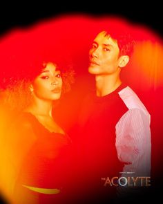 two people standing next to each other in front of a red and yellow background with the words tacolyte on it