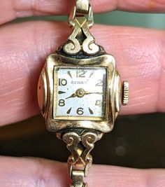 "This is a gorgeous Benrus 10K yellow rolled gold plated ladies watch that is currently NON working. I am not a watch expert, nor have I had it tested or serviced, it is being sold AS IS.  The face is a square with a pearly ivory face and gold hands and numerals. There is a lovely scroll design around the watch face that really sets it apart. The watch is marked 10k RGP on the back. This watch is approximately 6\". The band is a vintage segmented stretch band that also has a lot of visual intere Whimsigoth Art, Art Nouveau Wedding, Nouveau Wedding, Art Nouveau Weddings, Steampunk Style, Stretch Band, Stretch Bands, Scroll Design, Vintage Band