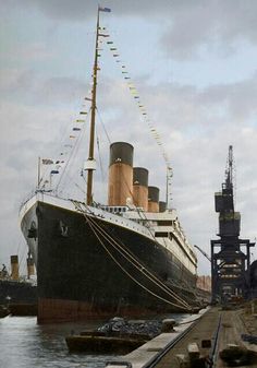 the large boat is docked at the dock