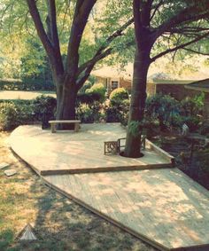 an outdoor patio area with trees and benches