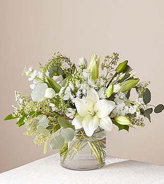 a vase filled with white flowers on top of a table