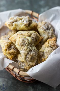 a basket filled with pastries sitting on top of a table next to a napkin