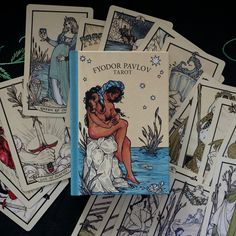 several tarot cards are laying on top of each other