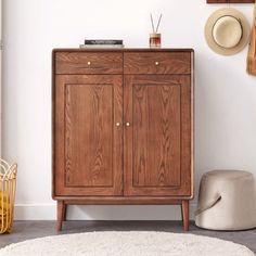 a wooden cabinet sitting on top of a white rug