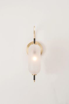 a wall light with a white glass shade