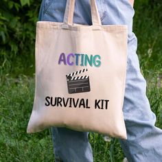 a person carrying a tote bag that says acting survival kit