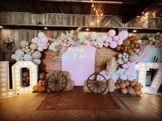 a decorated stage set up with balloons, hay bales and decorations for a baby shower