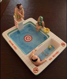 two figurines are sitting in a toy pool