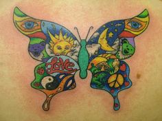 a colorful butterfly tattoo on the back of a woman's shoulder