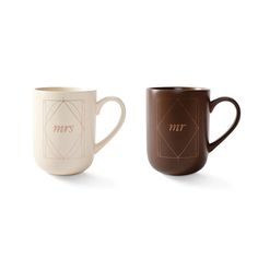 two coffee mugs, one brown and one white