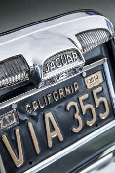 the front end of a car that is chrome and has a california license plate on it