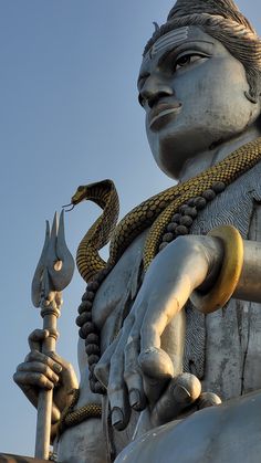 a statue with a snake on it's shoulder