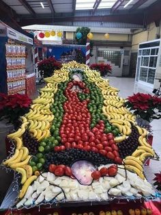 there is a large display of fruits and vegetables in the shape of a virgin mary