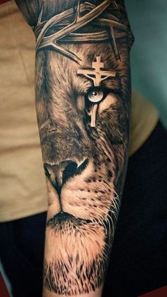 a man's arm with a lion and cross on it