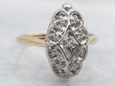 This sweet ring is a bit of an enigma. The style borders the Mid Century and Retro Eras but falls solidly into neither. The bright cut of the original, high-quality diamonds, however, tells us that this is the 20th Century in origin and in excellent condition!Metal: 14K Yellow and White GoldGem: 9 Diamonds totaling .05 Carats, SI-I in Clarity, G-H in ColorGem Measurements: 1.1 mm, RoundRing Size: 4.50Marks: "14K JC" Stamped on the inside band Dinner Ring, Sweet Ring, Retro Era, Diamond Accent Ring, Pocket Watch Chain, Watch Chain, The 20th Century, Vintage Diamond, Quality Diamonds