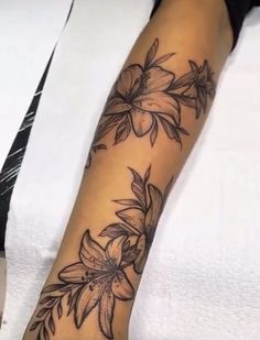 a woman's arm with flowers on it