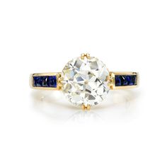 an old mine cut diamond and sapphire engagement ring with two tone gold band, set in 18k yellow gold