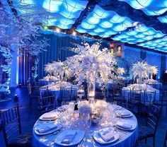 a table is set with white flowers and place settings for an elegant wedding reception at the four seasons resort