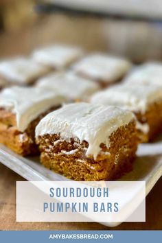 two pieces of pumpkin bars with white frosting on top and the words, sourdough pumpkin bars