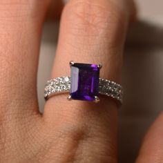 This ring features a 7*9mm natural amethyst and sterling silver finished with rhodium. Customization is available. It is made by hand, and it will take about 7 days to finish the ring after your payment is completed. Main stone: natural amethyst Amethyst weight: Approx 2.30 ct Metal type: sterling silver finished with rhodium Accent stone: cz Customization is available, I also can make it with 14k solid gold (white or yellow or rose) and diamond accent stone, just feel free to contact me. Any qu Purple Amethyst Engagement Ring, Emerald Cut Halo Ring, Emerald Cut Wedding Band, Amethyst Wedding Rings, Amethyst Ring Vintage, Micro Pave Ring, Amethyst Engagement Ring, Amethyst Ring Engagement, Dream Rings