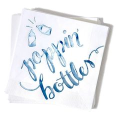 two napkins with blue lettering on them