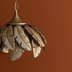 a light that has some kind of bird feathers hanging from it's ceiling fixture