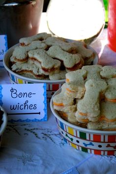 there are many different types of cookies in bowls on the table with name tags attached to them