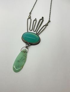 "This piece has MOXY  ....necklace style featuring this lush glow seafoam blue green vintage glass piece & epic chrsoprase dropwith eclectic metalwork detailsthis necklace will not disappoint!! made with oxidized sterling silver and vintage glass 3.25\" x 1.5\" x .25\".  this piece is handmade by me from start to finish in my studio in austin, texas. the piece is constructed of sterling silver, soldered, sanded, filed, hand set stone, oxidized, and sanded again and features a handmade clasp and is signed on the back.  due to the handmade nature of this piece there may be subtle differences between the piece pictured and the piece especially made from you.  please specify the length of chain you prefer in the notes to seller section. thanks for looking enjoy your awesome day **pieces will b Vintage Green Jewelry With Unique Variations, Green Cabochon Bohemian Necklaces, Handmade Modern Green Jewelry, Green Bohemian Cabochon Necklaces, Modern Handmade Green Jewelry, Green Handmade Modern Jewelry, Modern Green Handmade Jewelry, Artisan Green Turquoise Necklace With Large Pendant, Modern Green Cabochon Jewelry