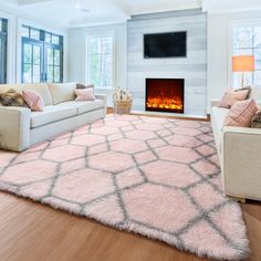 a living room filled with furniture and a fire place in the middle of the room