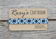 a blue and white bracelet on top of a piece of paper with the words rosy's craftroom