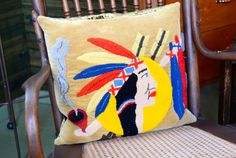 a cushion with an image of a native american woman on it sitting in a chair