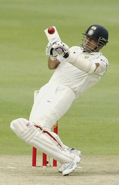 a cricket player hitting the ball with his bat