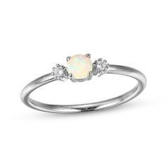 Update your stack with this dainty and colorful ring. Styled in sterling silver A round-cut lab-created opal cabochon is the petite focal point Round white lab-created sapphires flank the sides Opal Engagement Ring Silver Simple, White Opal Dainty Birthstone Ring, White Dainty Opal Birthstone Ring, Delicate Sterling Silver Opal Ring, Fine Jewelry Stackable Opal Promise Ring, Adjustable White Gold Opal Ring, Stackable Opal Promise Ring In Fine Jewelry Style, Delicate White Opal Round Ring, Adjustable White Gold Opal Ring In Fine Jewelry Style