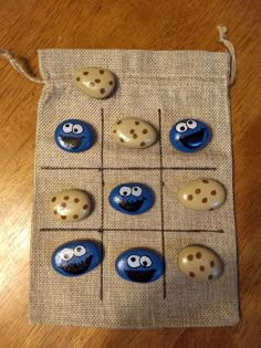 a bag filled with blue and white buttons sitting on top of a wooden table