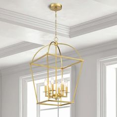 a chandelier hanging from the ceiling in a room with white walls and windows