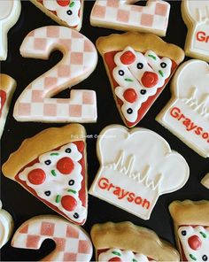 some cookies that have been decorated to look like pizzas and numbers for two on them