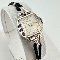 Vintage Cornell Cocktail watch with 17 jewels set in ornate 14k white gold case 17 Jewel Movement by Shriro Watch Co. is Made in Switzerland  Gold plated band fits wrists 6" however, the cord can be replaced with longer lengths if needed  Winds and keeps good time  Ships immediately Classic Adjustable Watches With Polished Finish, Timeless Adjustable Watch Accessories With Polished Finish, Classic White Gold Watch With Adjustable Band, Classic Silver Jewelry And Watches With Clasp, Vintage White Gold Jewelry With Round Dial, Elegant Adjustable Watch Bands With Polished Finish, Adjustable White Gold Watch With Bracelet Strap, White Gold Watches With Adjustable Bracelet Strap, Vintage Silver Watch Bands For Formal Occasions