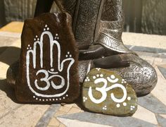 three rocks with designs on them sitting next to each other