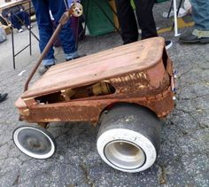 an old toy car is sitting on the ground