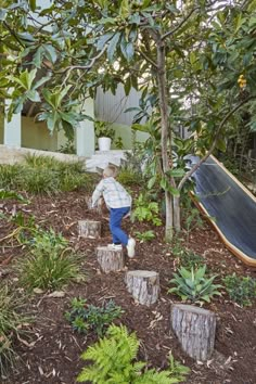 a young boy is playing in the garden