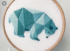 a bear made out of blue fabric in a hoop