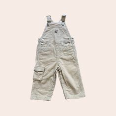 "Gymboree 90s Beige Utility Wide Corduroy Overall with LDrum Embroidery detail  on front pocket and Red Lining on Velcro Pocket Flaps. Utility pocket on right leg and two on back, snap on inside leg for easy change. 100% Cotton  Size: 6-12mo Waist Measurement: 22\" Leg Length: 17\" from mid waist, 9\" from inseam  xx" Corduroy Overall, Kids Overalls, Waist Measurement, Embroidery Details, Cargo Shorts, House Ideas, Overalls, Kids Outfits, Embroidery