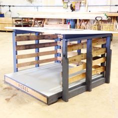 a table made out of wooden pallets in a workshop